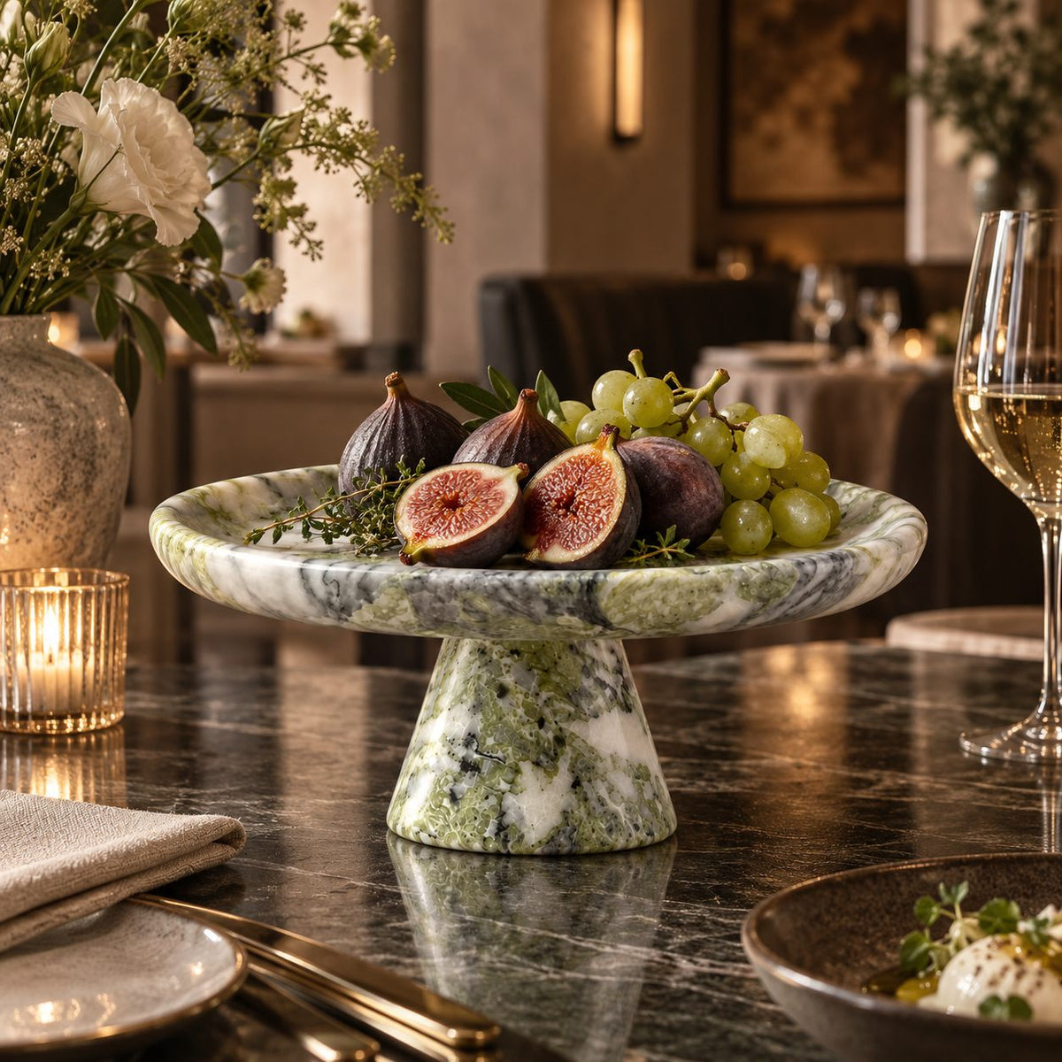 Verdant Relic pedestal tray styled with fruit in an art dining room