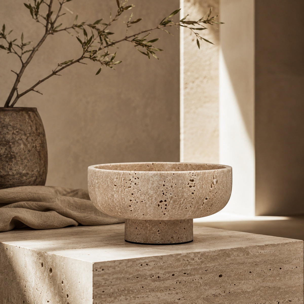 Terra cream travertine vessel showing natural pore and tonal variation
