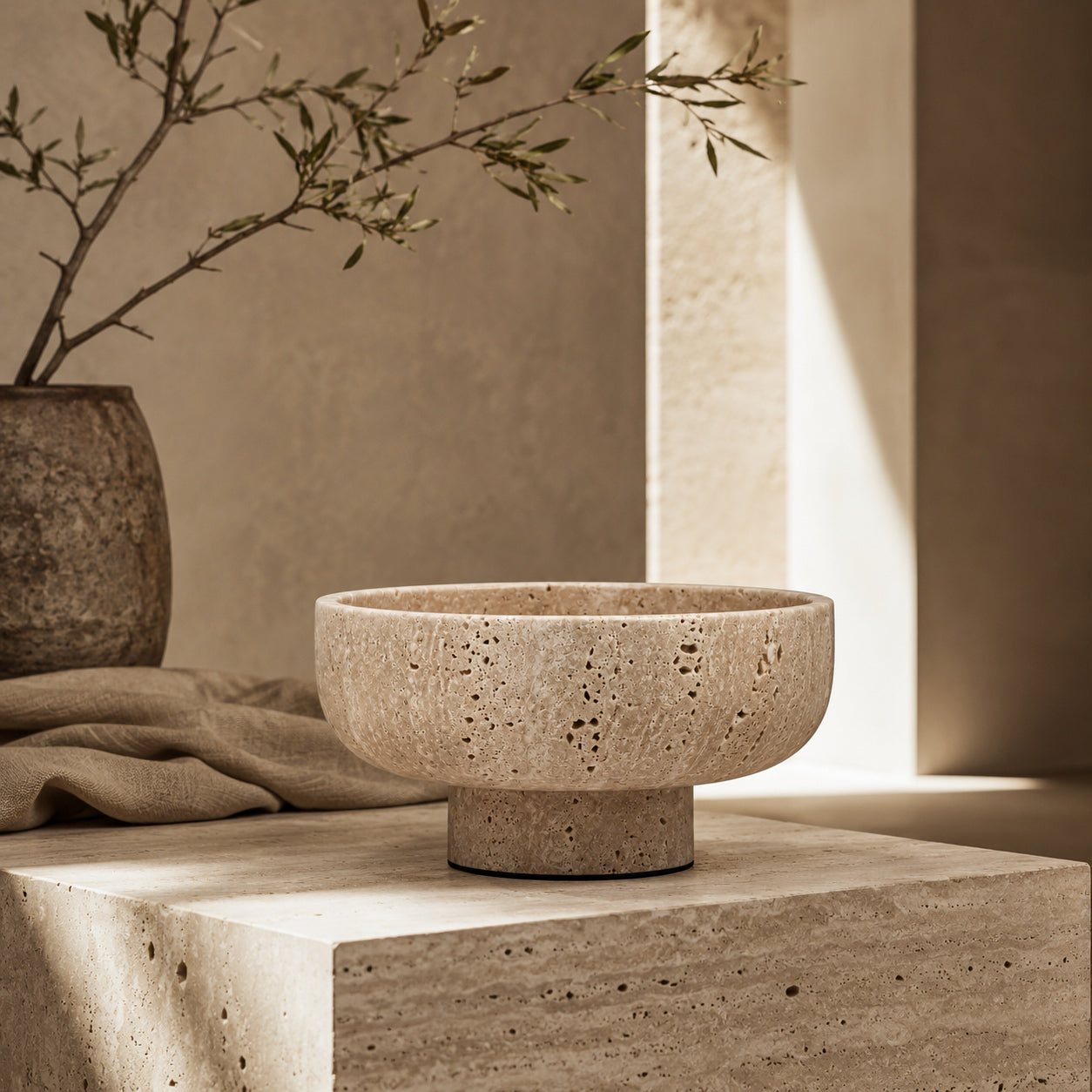Terra Cream Travertine vessel in a styled setting